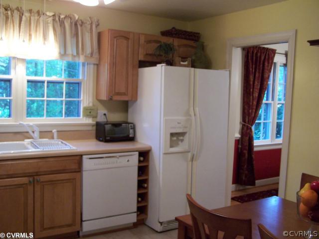 8026 Cherokee Road Richmond, VA 23225 - Photo 6 of 12 a kitchen with a sink a window and cabinets