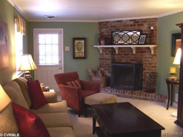 8026 Cherokee Road Richmond, VA 23225 - Photo 7 of 12 a living room with furniture and fireplace