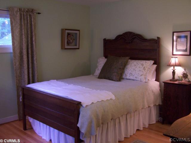 8026 Cherokee Road Richmond, VA 23225 - Photo 9 of 12 a bedroom with a bed and a window