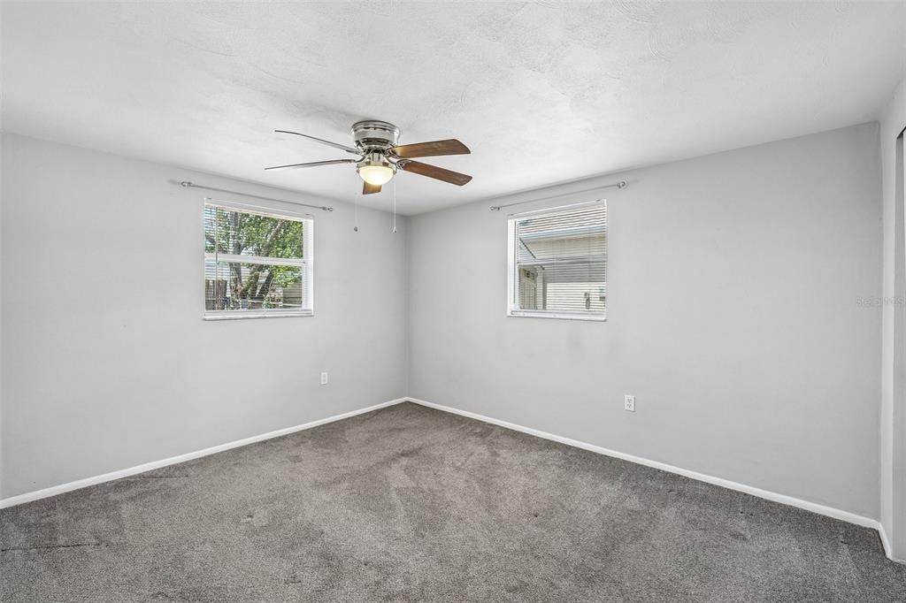 7215 Mayfield Drive Port Richey, FL 34668 - Photo 12 of 52 a view of room with a ceiling fan