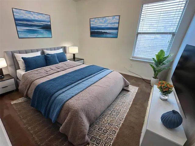 a bed sitting in a bedroom next to a window