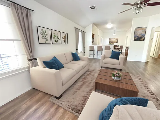 a living room with furniture and a large window