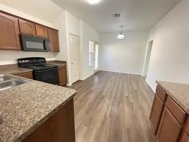 a kitchen with a sink stove and refrigerator