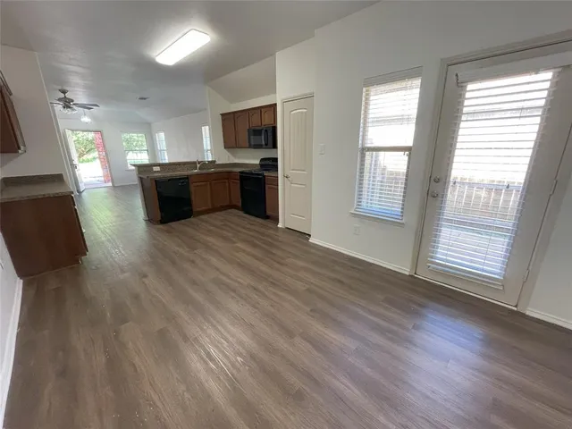 a view of kitchen with cabinets and wooden floor
