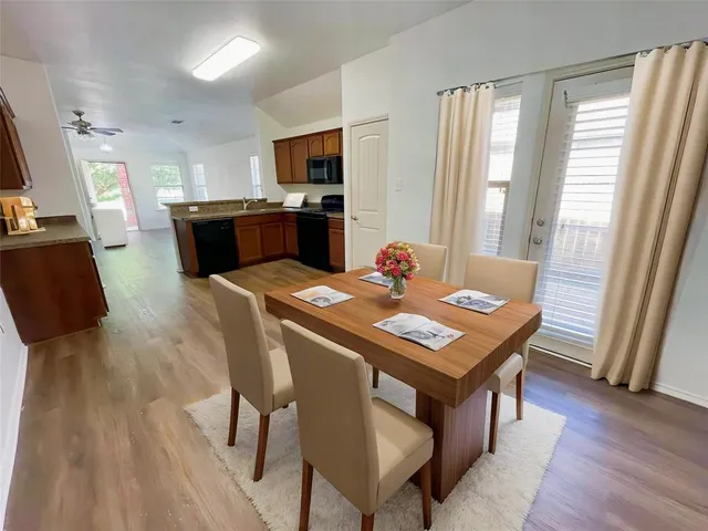 a view of a dining room with furniture and wooden floor