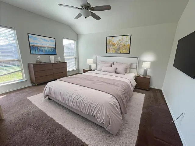 a bedroom with a large bed and a window