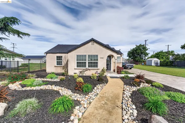 a front view of a house with garden