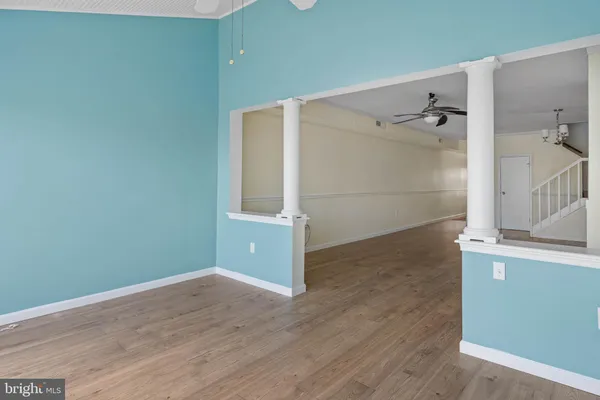 a view of a room with wooden floor