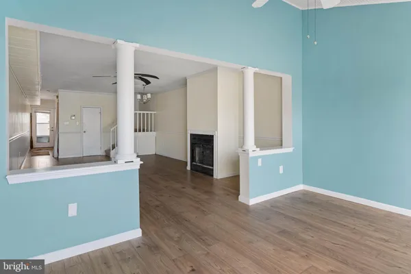 wooden floor in an empty room with a window