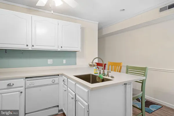 a kitchen with white cabinets and white appliances