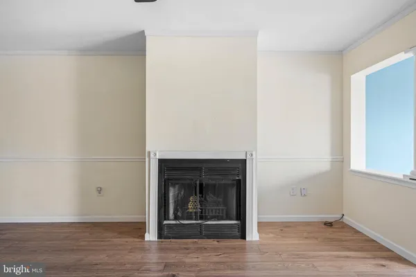a view of a livingroom with wooden floor and a window