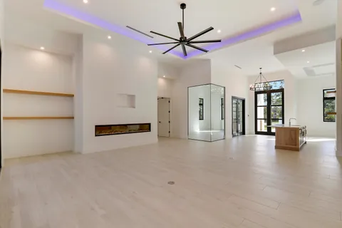 a kitchen with white cabinets and sink