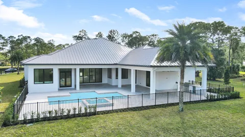 a large kitchen with stainless steel appliances a large counter top a refrigerator and a stove