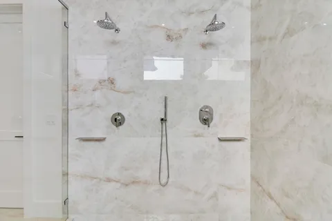 a view of a bathroom with a tub and window