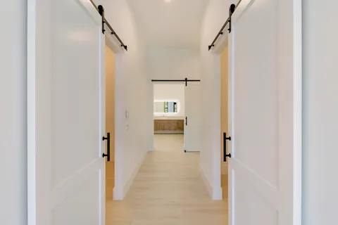 an aerial view of residential houses with outdoor space and trees