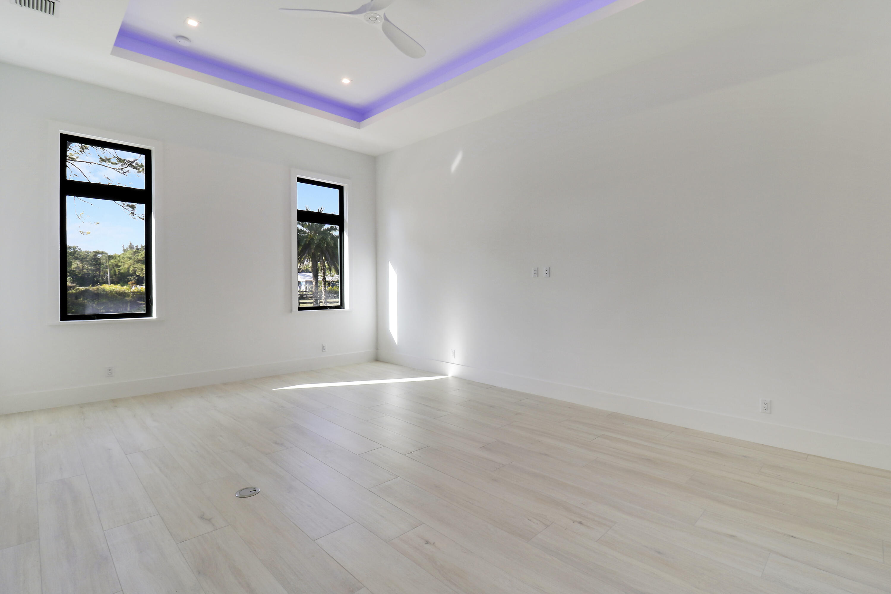 14527 Pepper Bush Drive Palm Beach Gardens, FL 33418 - Photo 29 of 81 a view of an empty room with wooden floor and a window