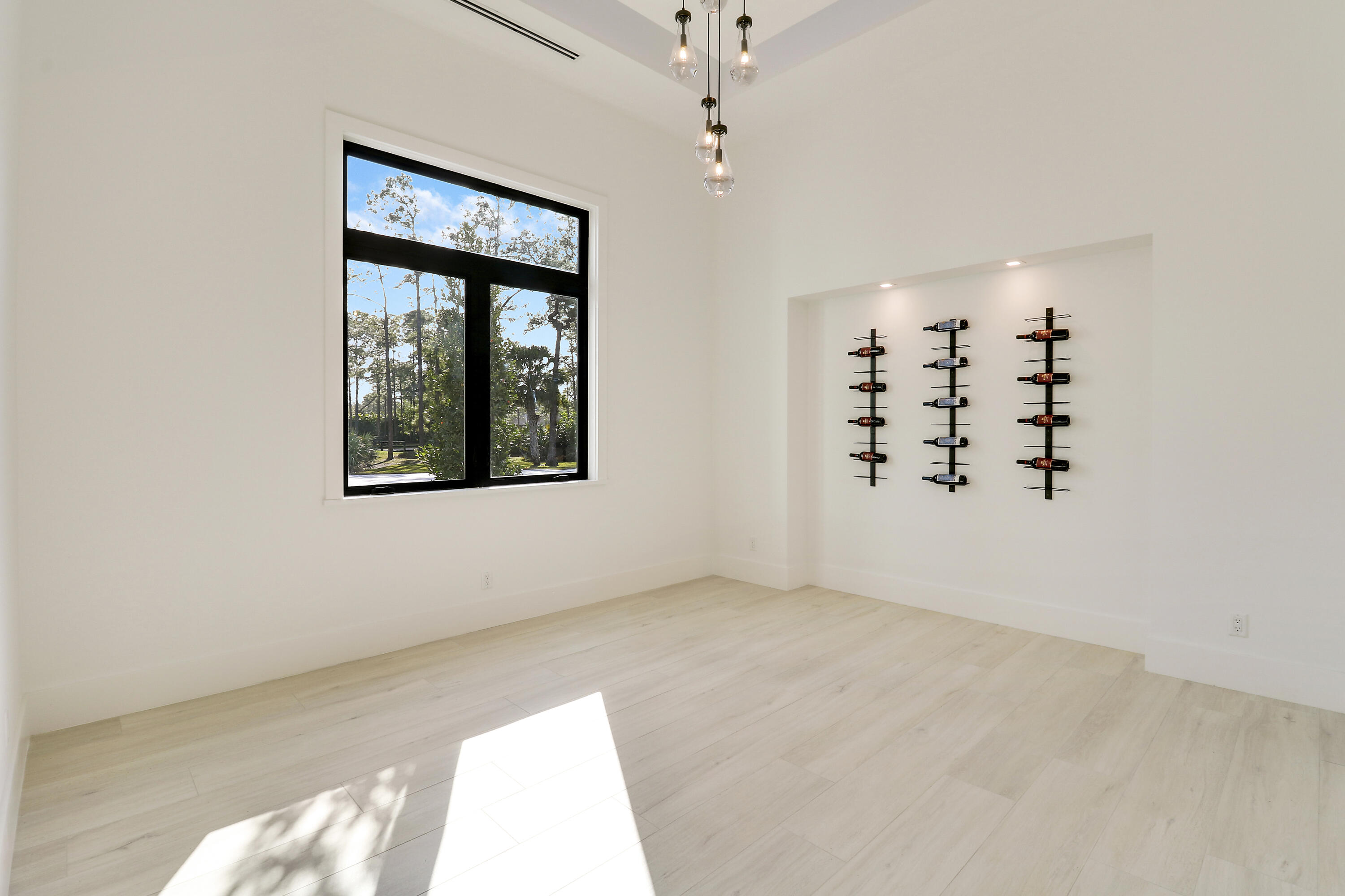 14527 Pepper Bush Drive Palm Beach Gardens, FL 33418 - Photo 45 of 81 an empty room with windows and chandelier fan