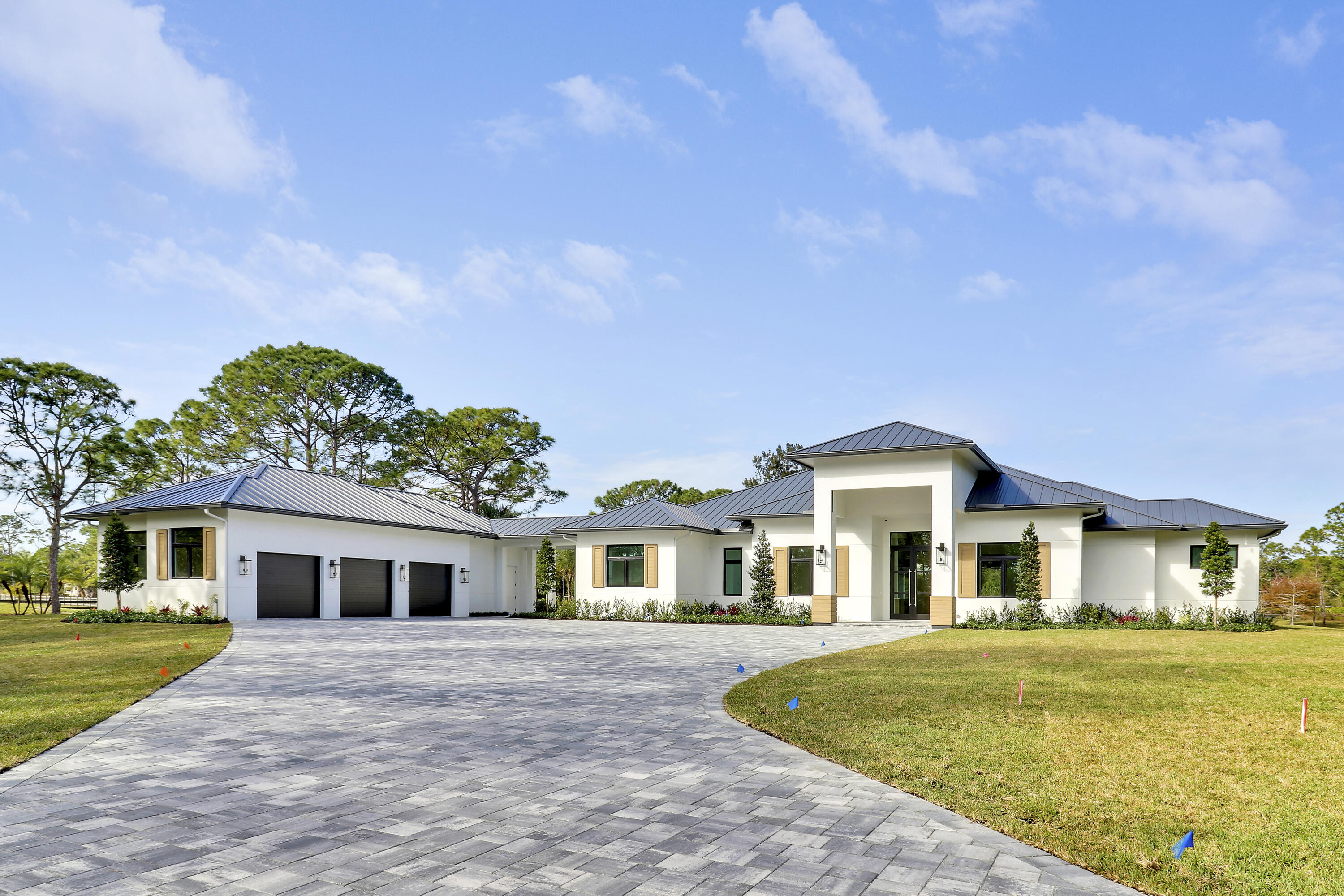 14527 Pepper Bush Drive Palm Beach Gardens, FL 33418 - Photo 68 of 81 a front view of a house with a garden