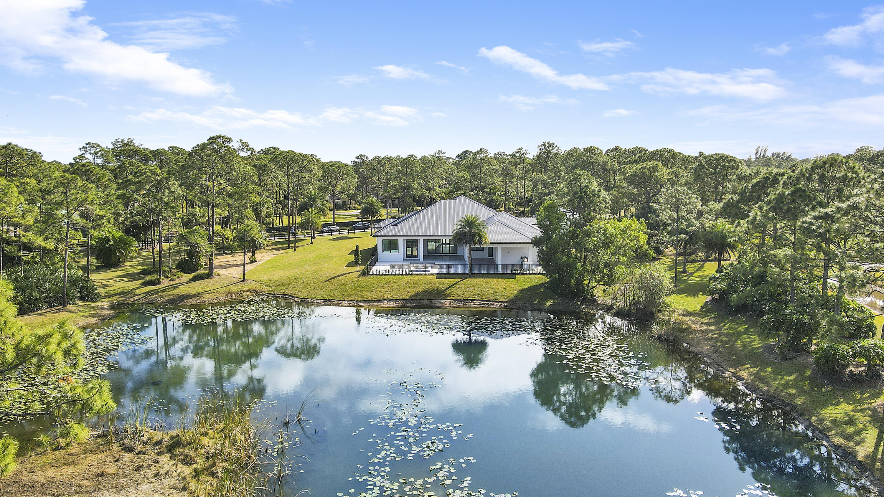 14527 Pepper Bush Drive Palm Beach Gardens, FL 33418 - Photo 74 of 81 a swimming pool with wooden fence