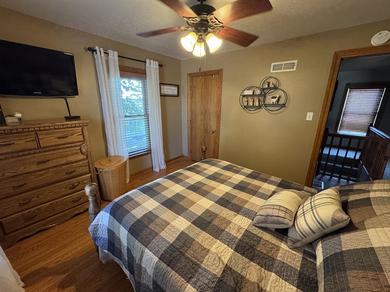 80 Snow Street Chadwick, IL 61014 - Photo 40 of 44 a bedroom with a bed and a flat tv screen on the dresser