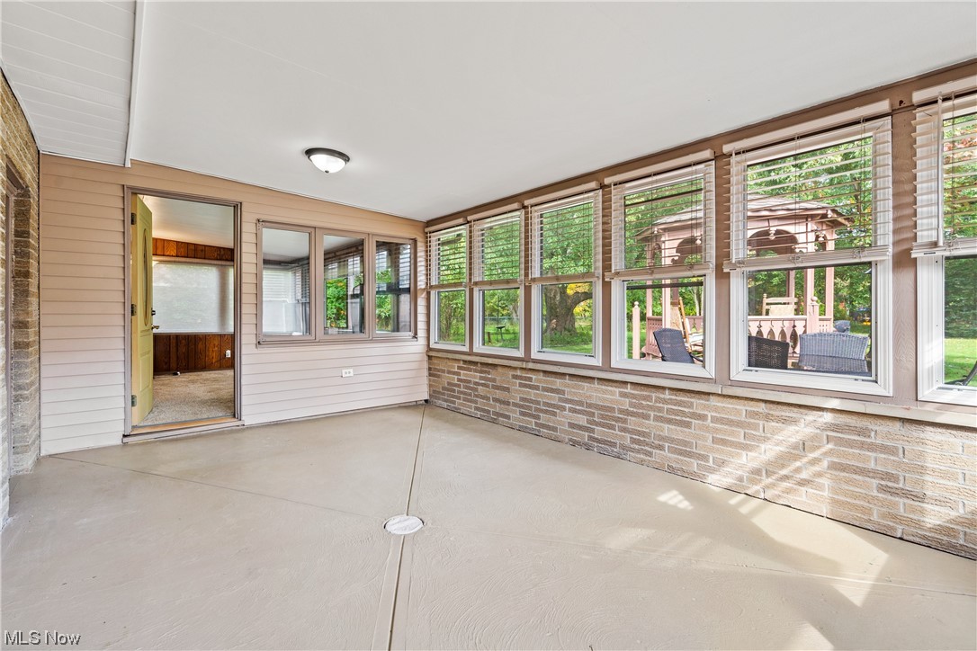 8899 Priem Road Strongsville, OH 44149 - Photo 22 of 35 Unfurnished sunroom featuring vaulted ceiling and a wealth of natural light
