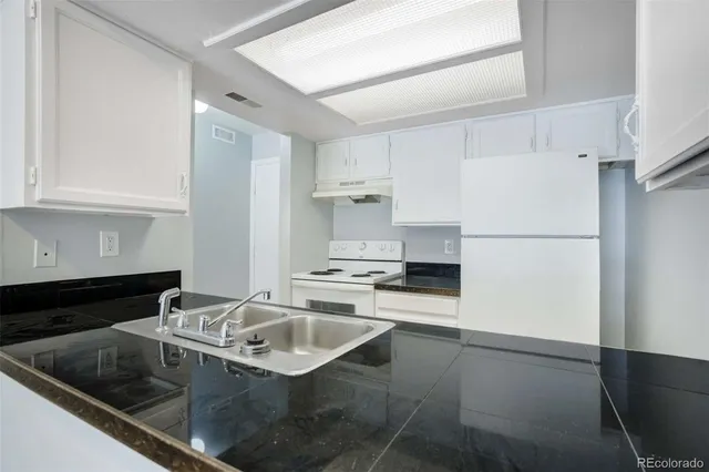 a kitchen with a sink stove and refrigerator