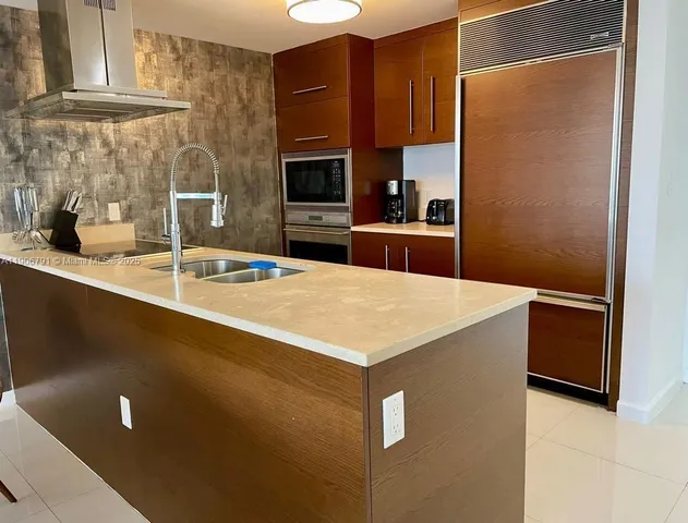 a kitchen with stainless steel appliances a refrigerator and a sink