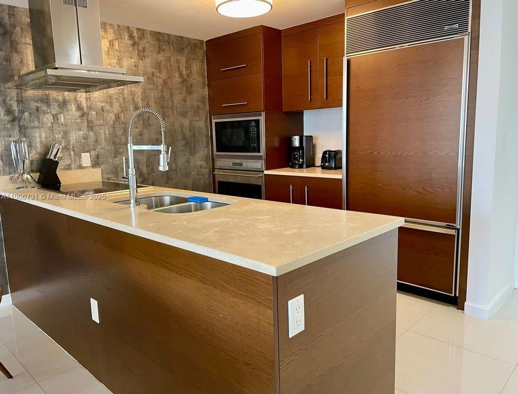 485 Brickell Avenue, Unit 3607 Miami, FL 33131 - Photo 11 of 36 a kitchen with stainless steel appliances a refrigerator and a sink