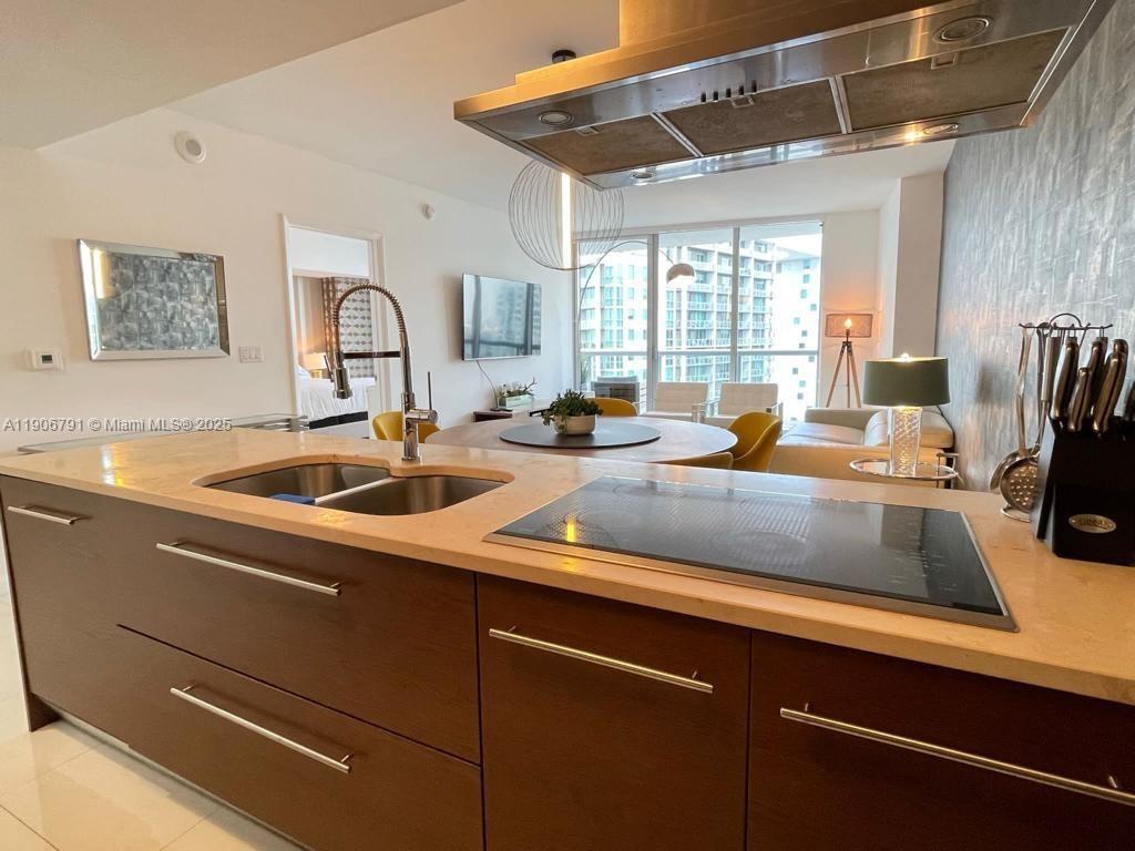 485 Brickell Avenue, Unit 3607 Miami, FL 33131 - Photo 12 of 36 a kitchen with a sink cabinets and window