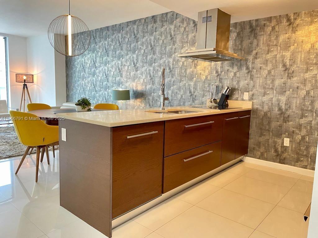 485 Brickell Avenue, Unit 3607 Miami, FL 33131 - Photo 13 of 36 a kitchen with a sink and cabinets