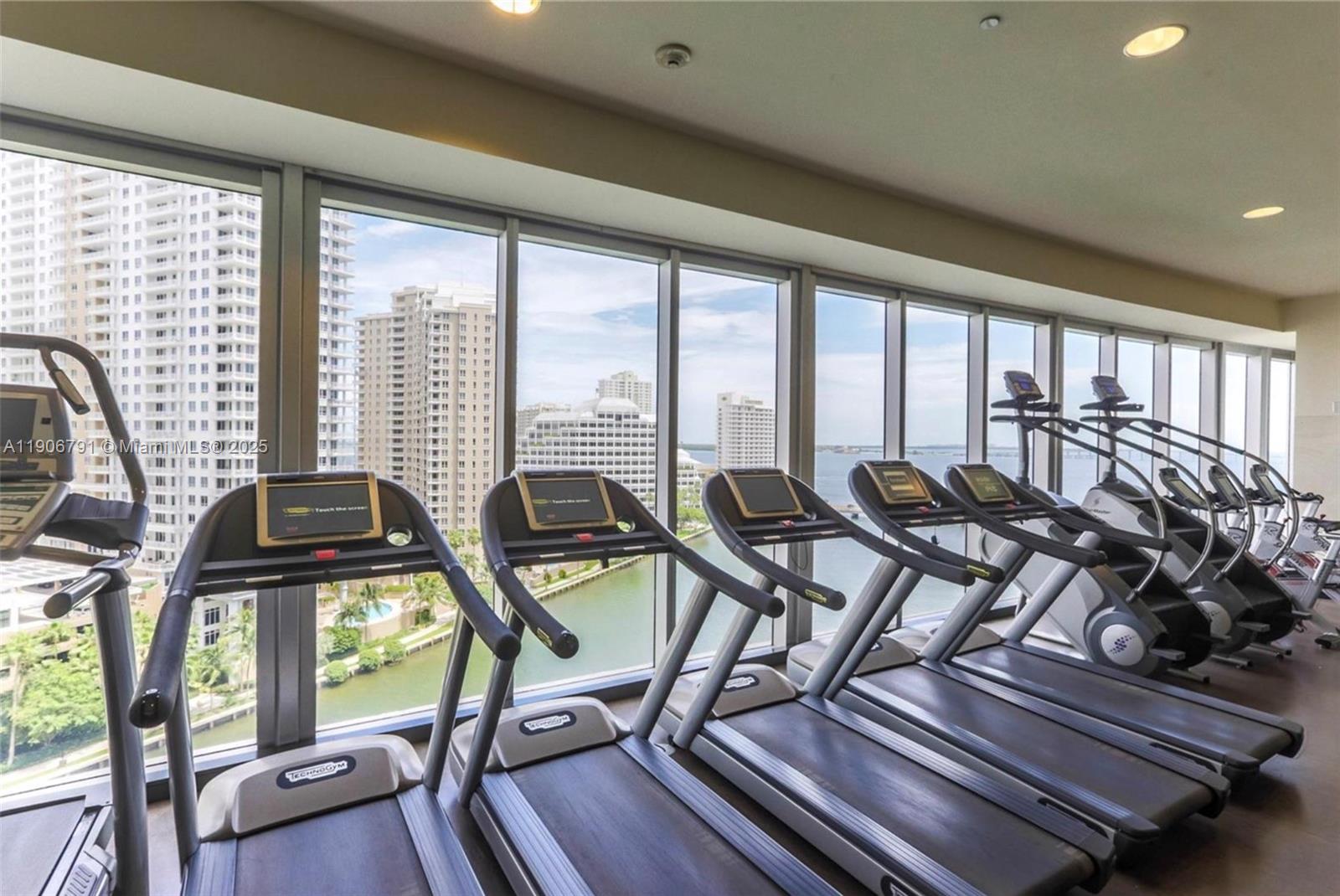485 Brickell Avenue, Unit 3607 Miami, FL 33131 - Photo 31 of 36 a view of a dining room with furniture large windows and wooden floor