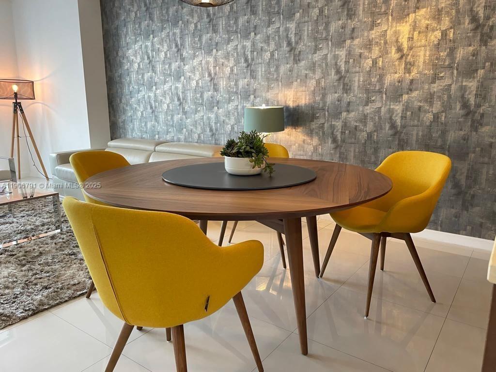485 Brickell Avenue, Unit 3607 Miami, FL 33131 - Photo 4 of 36 a view of a dining room with furniture and wooden floor