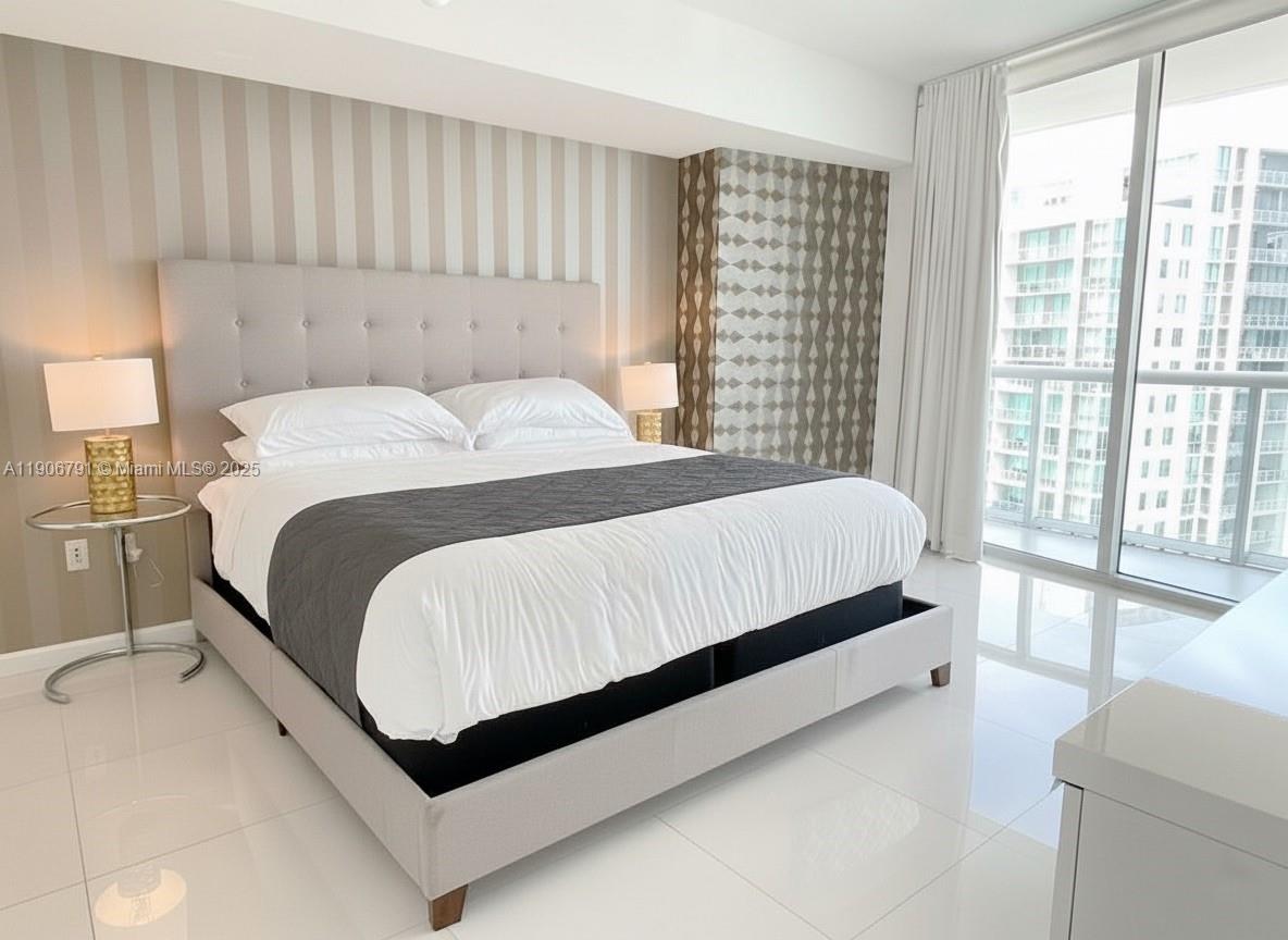 485 Brickell Avenue, Unit 3607 Miami, FL 33131 - Photo 6 of 36 a bedroom with a large bed and a large window