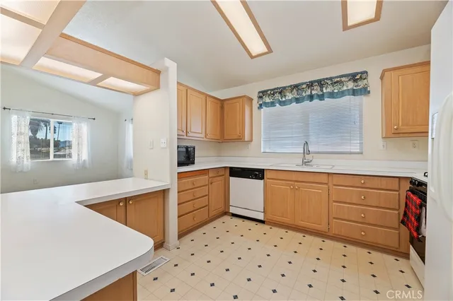 a kitchen with granite countertop a sink and cabinets