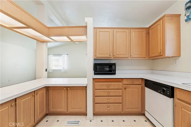 a kitchen with granite countertop white cabinets and sink