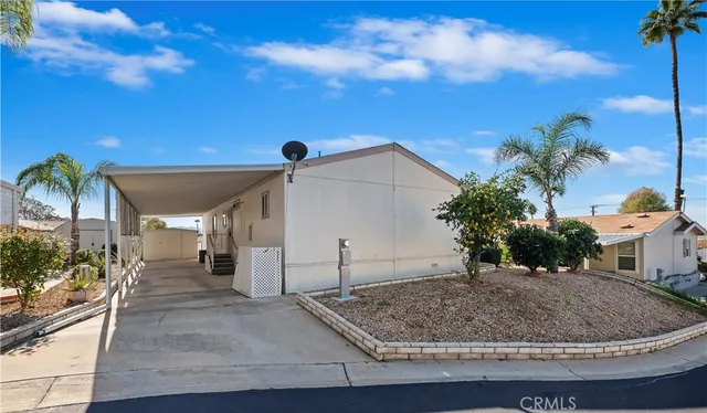 a view of a house with a dry yard and a garage