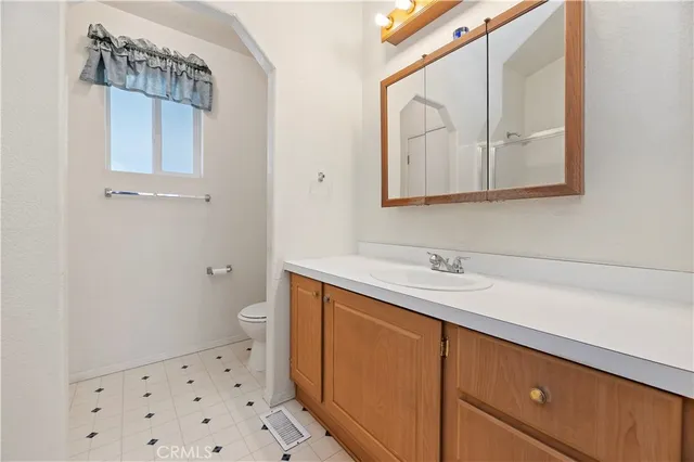 a bathroom with a sink a toilet and mirror