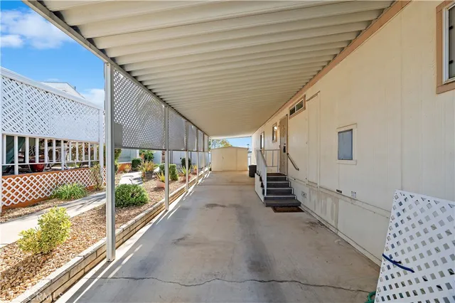 a view of a porch with wooden floor and iron fence