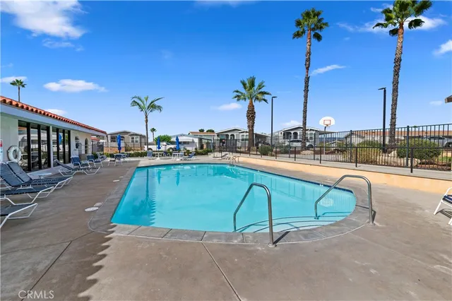 a swimming pool with outdoor seating and yard