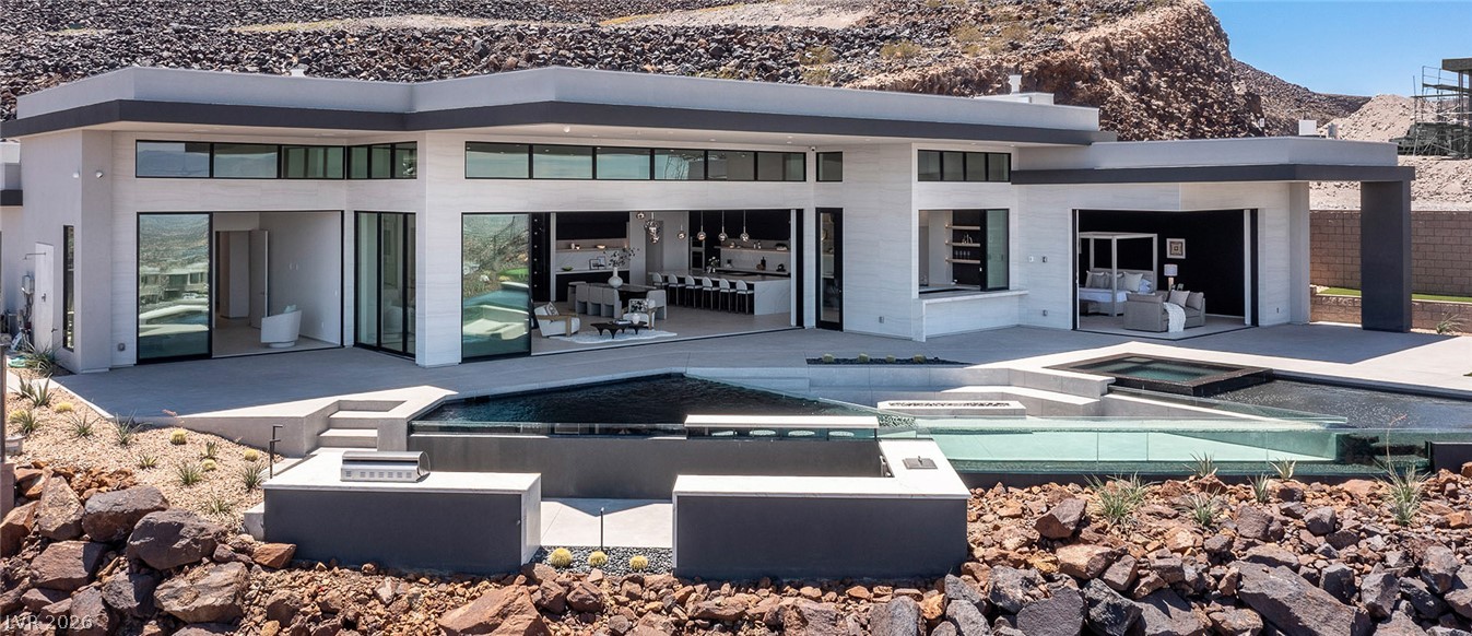 563 Grand Rim Drive Henderson, NV 89012 - Photo 63 of 70 An architectural marvel seamlessly blends indoor and outdoor living with a private pool, spa, and outdoor grill.
