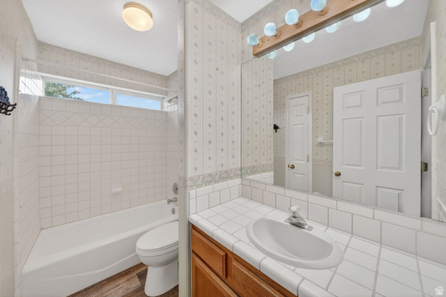 1464 990 West Provo, UT 84601 - Photo 23 of 41 Bathroom featuring a vanity with a drop-in sink, tiled countertop, and a large wall mirror