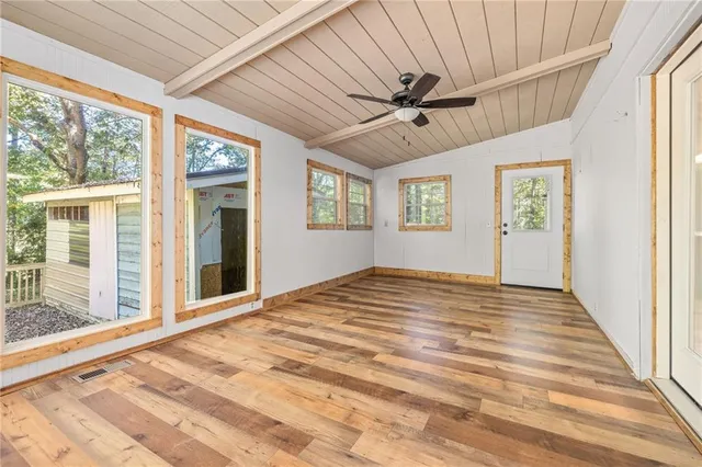 a view of empty room with window and ceiling fan