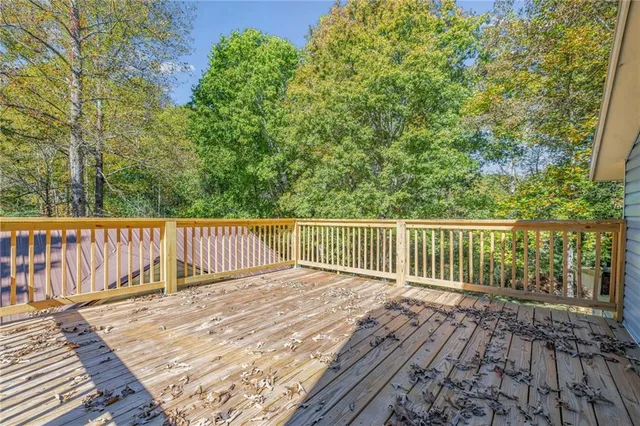 a balcony with view of trees in the background