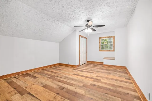 a view of a bedroom with a bed and a chandelier fan