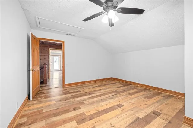 a bathroom with a granite countertop toilet sink and mirror