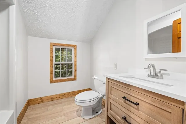 a white bath tub sitting next to a white wooden cabinet