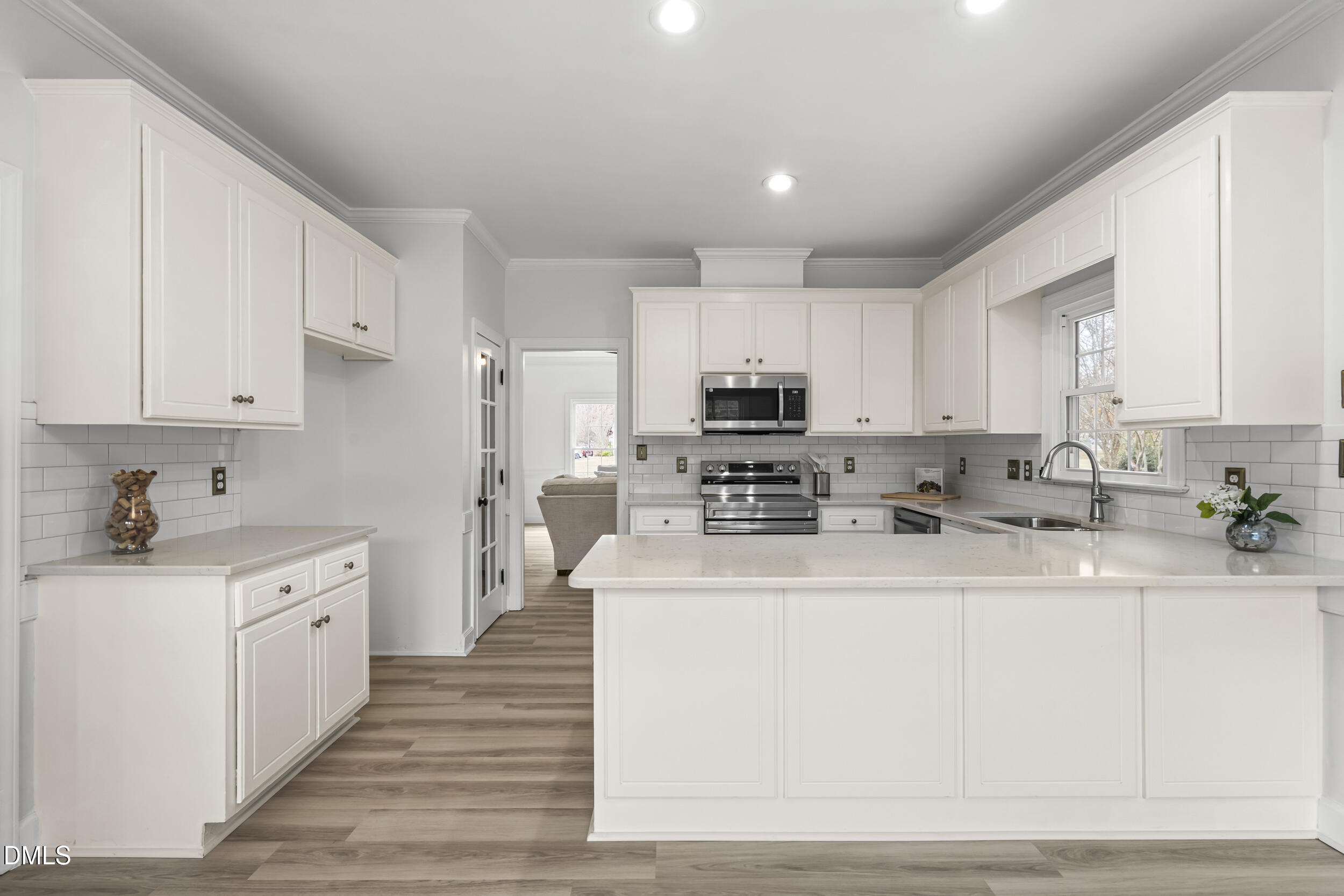 1213 Buxton Road Northwest Wilson, NC 27896 - Photo 12 of 36 a kitchen with stainless steel appliances granite countertop a sink dishwasher a refrigerator and white cabinets with wooden floor