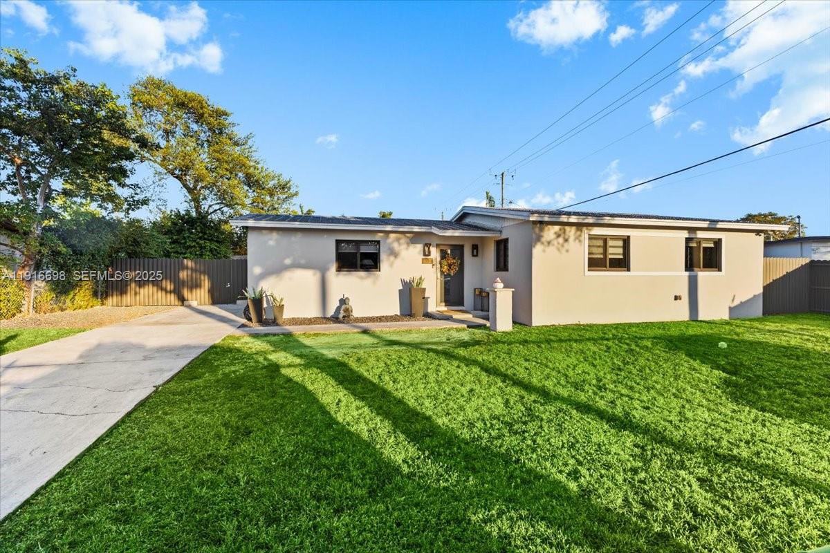 17121 Northwest 82nd Avenue Hialeah, FL 33015 - Photo 1 of 29 a view of a white house with backyard and a garden