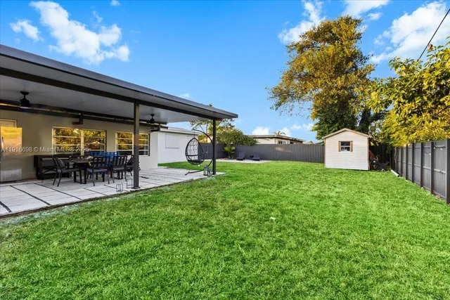a front view of a house with garden and sitting area