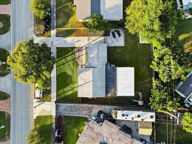 an aerial view of a house with a yard swimming pool patio and outdoor seating